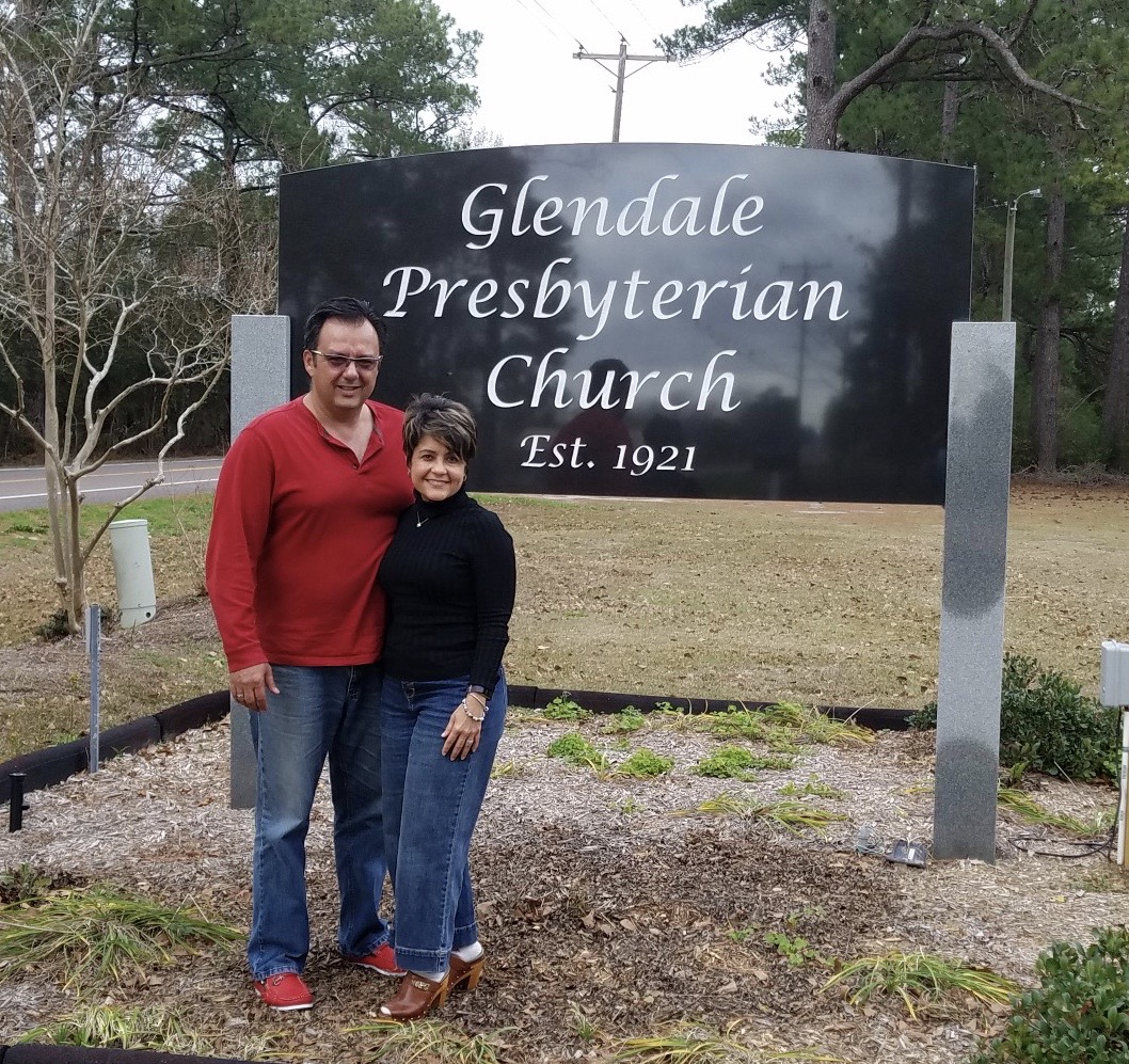 Efrain Sanchez and Enid Flores standing in front of Glendale Presbyterian sign